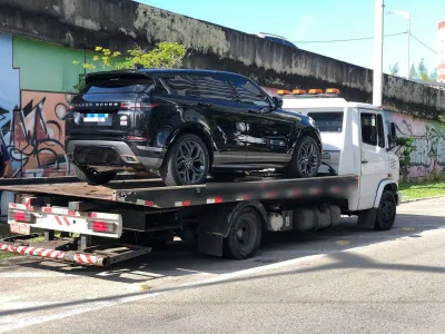 Range Rover preta transportada na plataforma do guincho